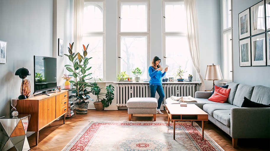 woman hanging out in her house by radiator 